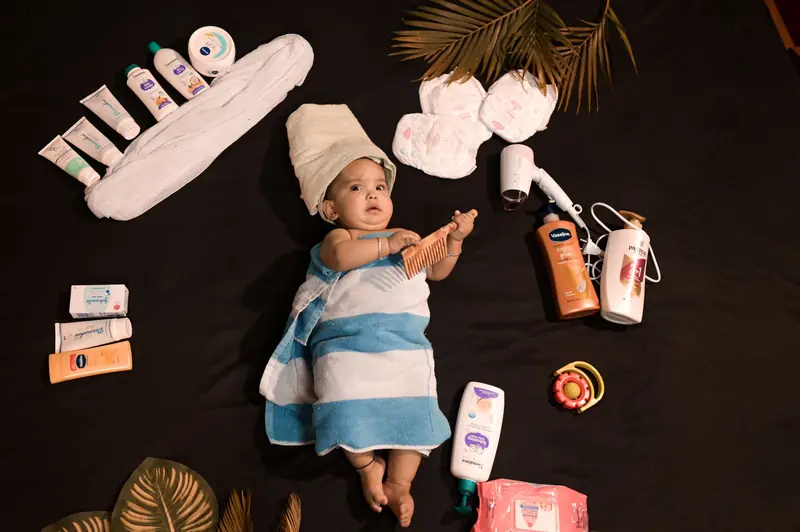Adorable baby wrapped in towel with skincare essentials. Perfect for beauty and childcare themes