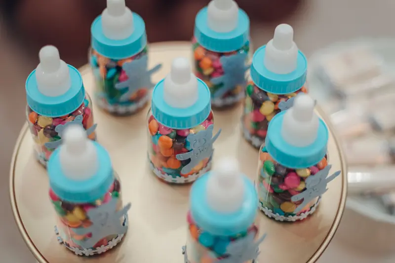 Close-up of colorful candies in baby bottles arranged for a festive occasion