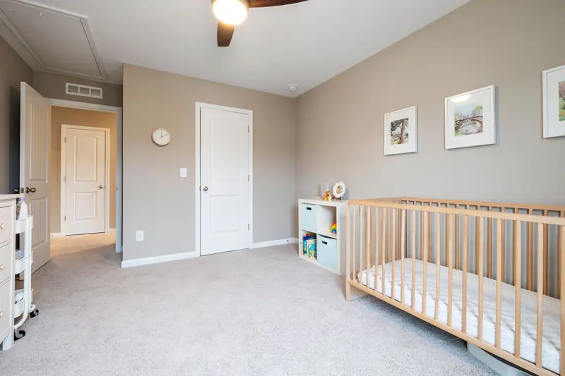 Bright and cozy nursery room with a wooden crib and modern decor